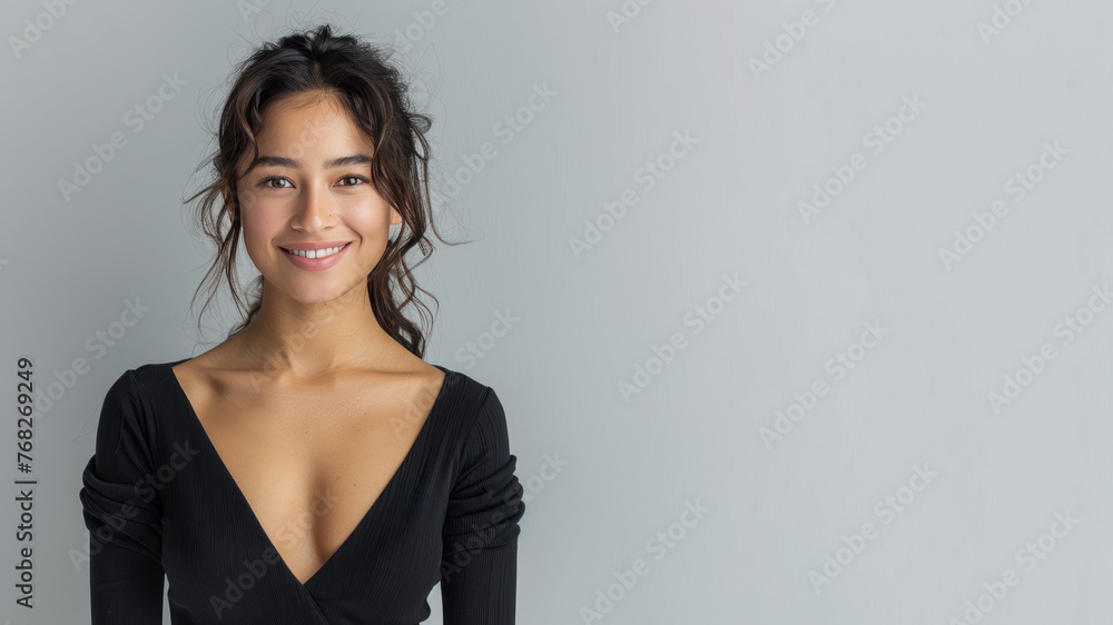 Hispanic woman wearing black ribbed V-Neck Body smiling isolated on gray Hispanic woman wearing black ribbed V-Neck Body smiling isolated on gray