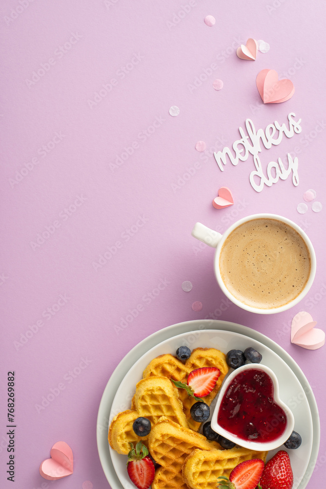 Mother's Day breakfast delight: overhead vertical photo showing heart waffles, strawberries, blueberries, marmalade, espresso on a soft purple background, space for text Mother's Day breakfast delight: overhead vertical photo showing heart waffles, strawberries, blueberries, marmalade, espresso on a soft purple background, space for text