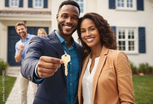 A cheerful couple holds up keys to their new house, their excitement and pride in homeownership evident. photo