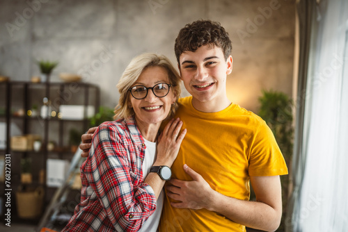 фотографія portrait of mother and son mature woman and young man at home happy