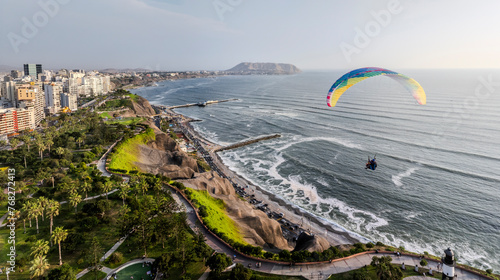 Paragliders in Miraflores, Lima, flies peacefully over the Miraflores boardwalk. It is possible to appreciate the Pacific Ocean, the Costa Verde, the buildings and the parks that border the cliff.