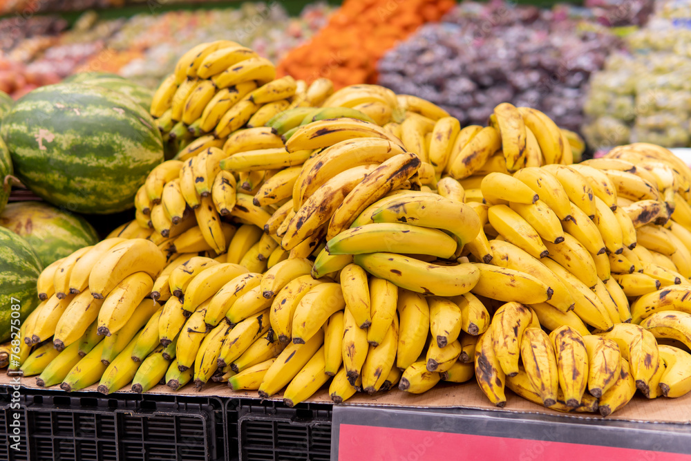 Group of bananas piled up on a supermarket hanger