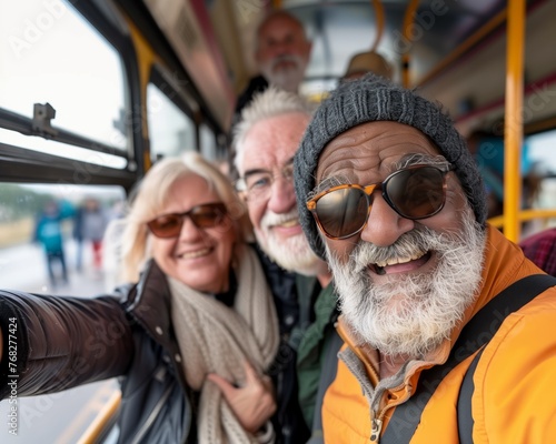 Selfie photo of 3 modern aged people moving forward smiling happily inside a bus, while traveling. Active retirement concept