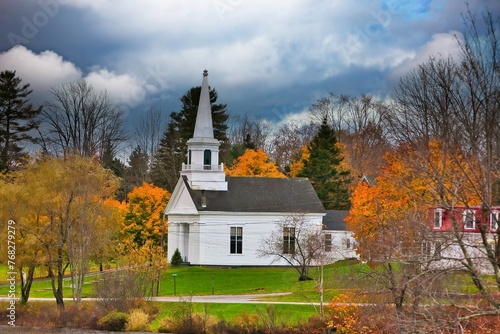 Orland United Methodist  church with trees showing fall colors, Orland, Maine. photo