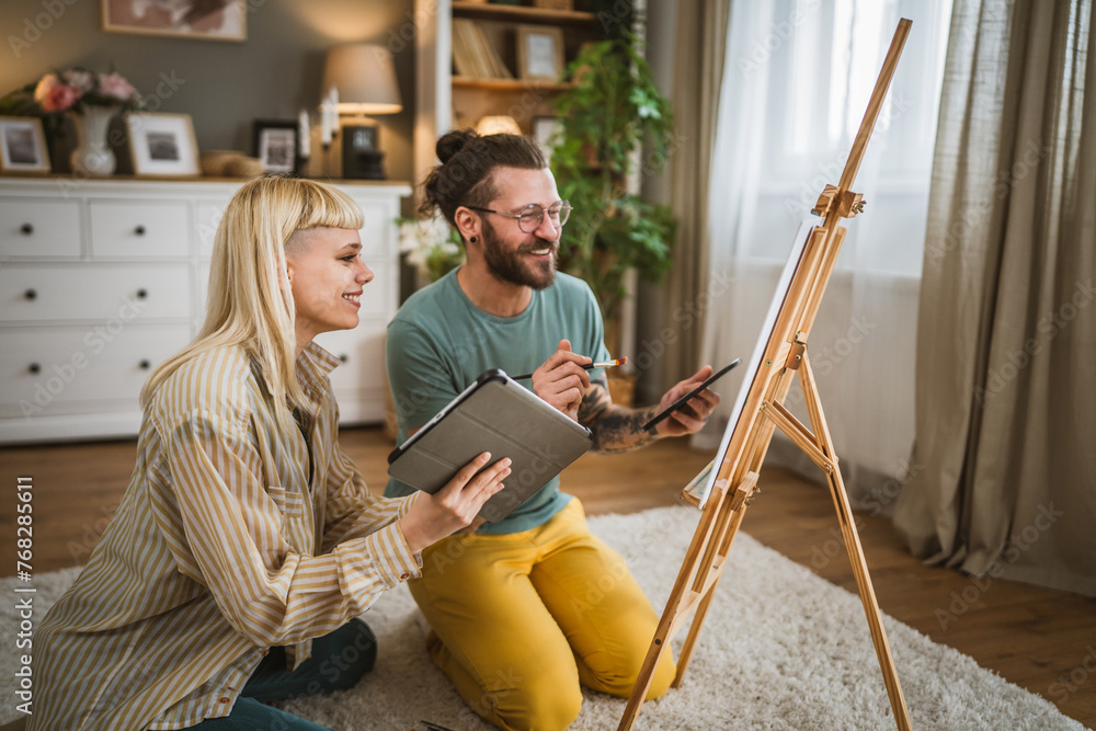 couple man and woman paint on canvas on easel at home leisure hobby