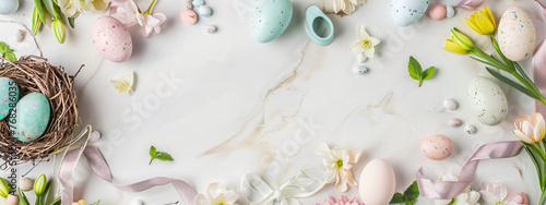 Frame with colored Easter eggs and spring flowers on light pastel background. Happy Easter concept. Simple spring template, greeting card, banner. Top view, flat lay with copy space