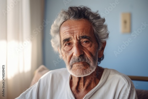 Portrait of a senior hispanic man in nursing home photo