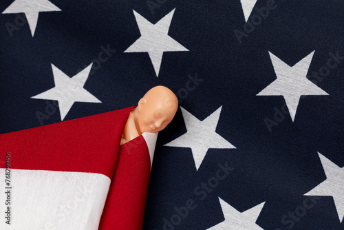 Fetus swaddled in American flag. Abortion rights, reproductive law and abortion access concept.