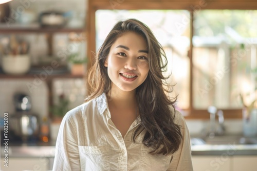 A radiant smile and sun-kissed backdrop highlight the beauty and happiness of a young woman in a comfortable kitchen Free Download A radiant smile and sun-kissed backdrop highlight the beauty and happiness of a young woman in a comfortable kitchen - GFXLoad