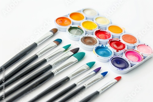 A bright and inviting array of watercolor paints and brushes, positioned on a pristine white background ready for artistic expression