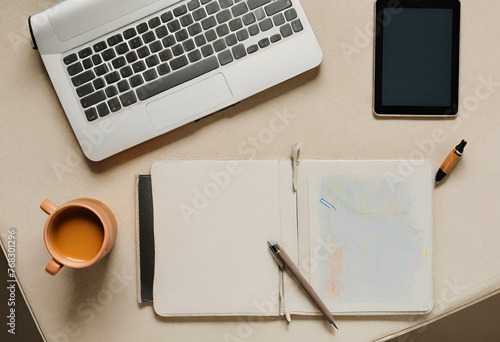 Top view of a minimalist desk with a tablet and pens on it