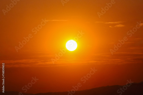 The sun at sunset in summertime