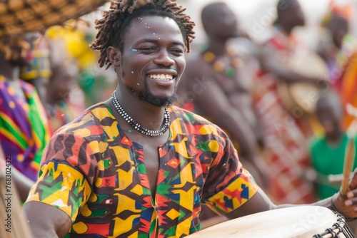 Drummer with a bright smile playing a djembe at a colorful cultural festival event
