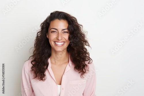 Portrait of a happy young businesswoman smiling at the camera while standing against white background © Chacmool