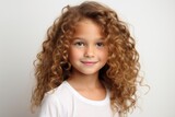 Beautiful little girl with long curly hair on a white background.