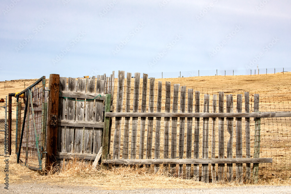 An old wooden windbreak fence a prairie ranch to protect cattle in the winter
