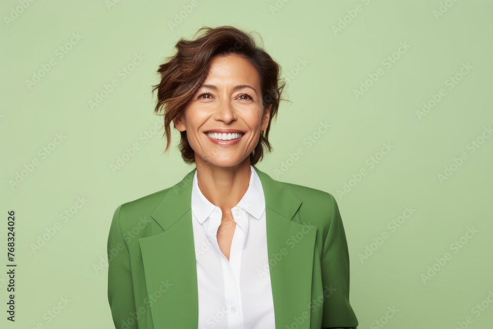 Portrait of happy mature business woman looking at camera, over green background Portrait of happy mature business woman looking at camera, over green background
