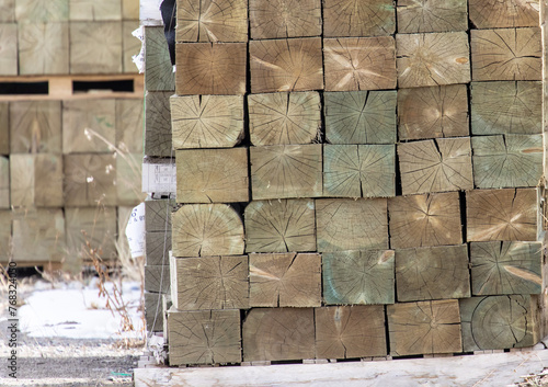 end grain of stacks of heavy industrial square pressure treated 6x6 lumber photo