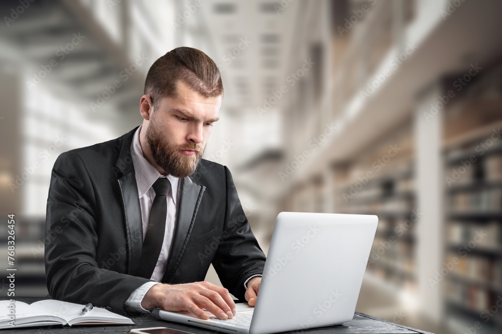 Smart male student at desk using laptop, Smart male student at desk using laptop,