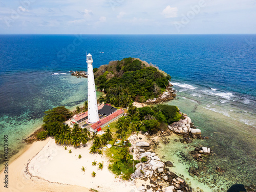 Belitung beach and islands drone view with Lengkuas Island lighthouse. Beautiful aerial view of islands, boat, sea and rocks in Belitung, Indonesia 