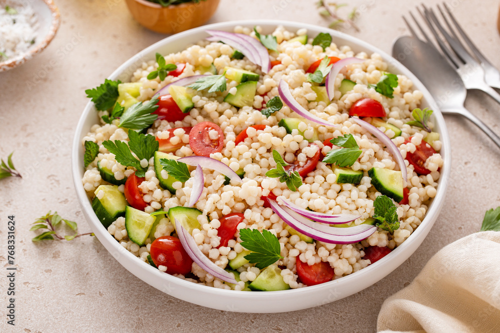 Pearl couscous salad with fresh vegetables and herbs, healthy side dish idea Pearl couscous salad with fresh vegetables and herbs, healthy side dish idea