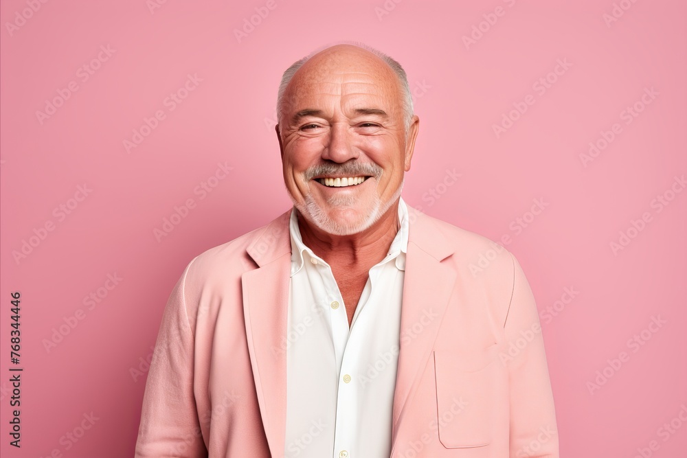 Portrait of a happy senior man with a white beard on a pink background Portrait of a happy senior man with a white beard on a pink background