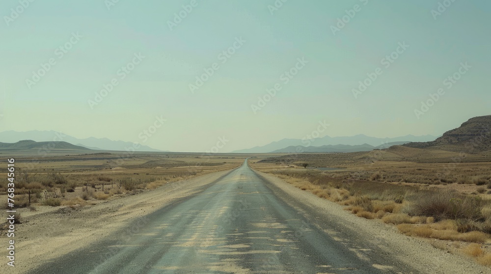 Desolate empty road stretching through a desert. Road travel on vacation. Relax trip in holiday Desolate empty road stretching through a desert. Road travel on vacation. Relax trip in holiday