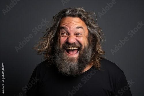 Handsome man with long beard and mustache shouting over grey background