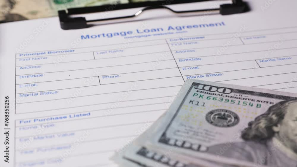 Mortgage Loan Agreement form document with US dollar bills Mortgage Loan Agreement form document with US dollar bills