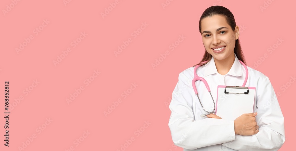 Portrait of female doctor with clipboard on pink background with space for text Portrait of female doctor with clipboard on pink background with space for text