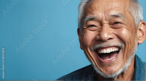young filipino elderly man on plain bright blue background laughing hysterically looking at camera background banner template ad marketing concept from Generative AI