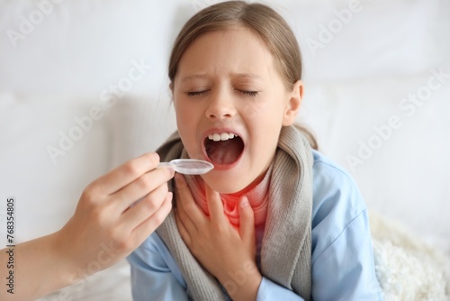 Ill little girl taking coug...