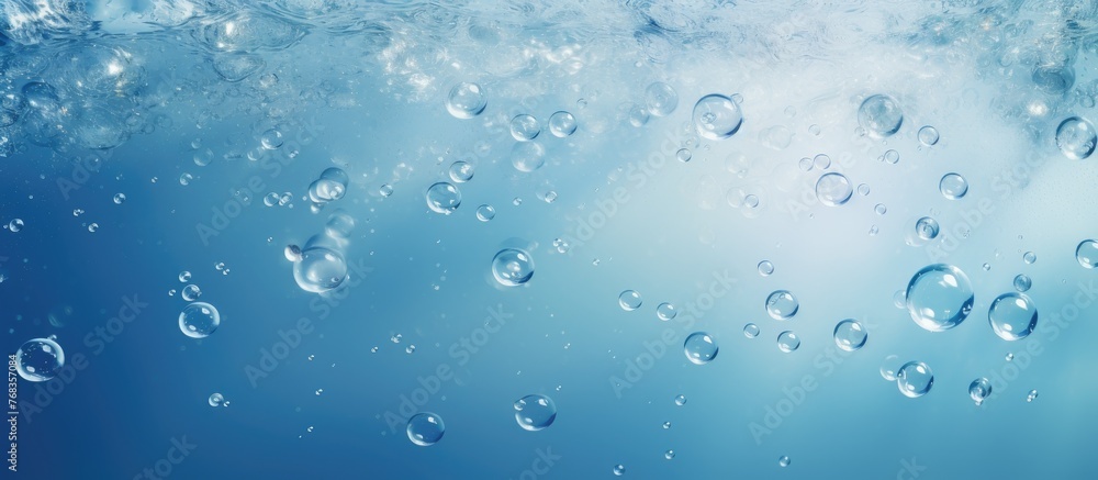 Numerous bubbles gently floating and shimmering in crystal clear water under a serene blue sky