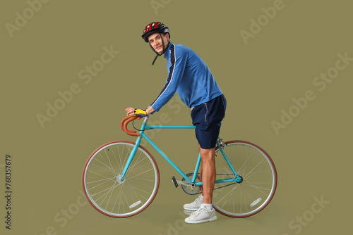 Young man riding bicycle on...