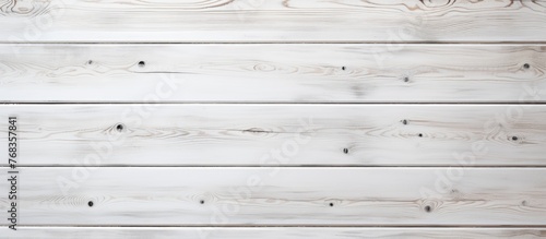 A closeup shot of a rectangle white hardwood table with parallel planks and wood stain pattern. The blurry background emphasizes the beauty of the wood