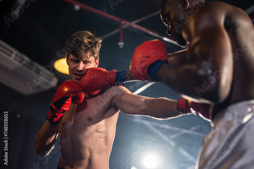 Two young professional boxer having a competition tournament on stage.  © Kawee