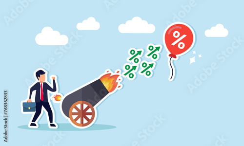 FED, Central Bank inflation mitigation strategy increase interest rates to regulate inflationary pressures, concept of Banker businessman fires interest rate cannon at inflation balloon photo