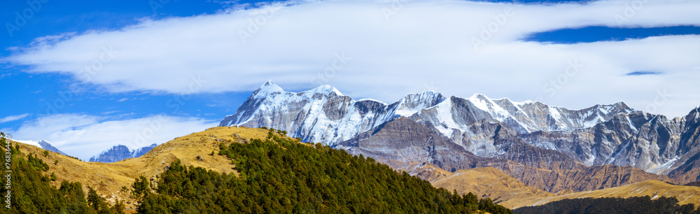  Panoramic landscape with sky.  Scenic mystic view of Himalayan peaks such as Mt. Trishul, Mt Nanda Ghunti and Mt. Khamet. At an altitude of 3800 m. On way to Bramhatal trek, Lohajung, Uttarakhand, 