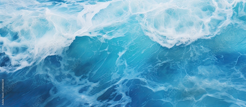 Obraz premium A close up of a wind wave in the ocean, showcasing the electric blue liquid of the water in a mesmerizing pattern. Perfect for recreation or a natural landscape in a swimming pool