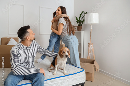 Happy family with dog in be...