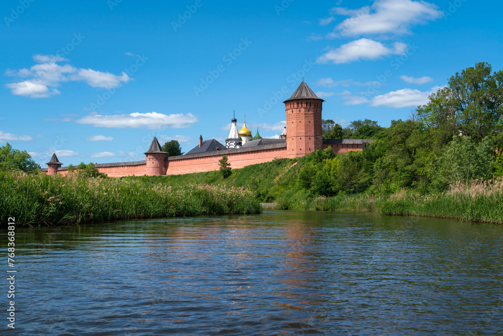 View of the Spaso-Evfimiev Monastery (a monastery of the Vladimir Diocese of the Russian Orthodox Church) on the bank of the Kamenka River on a sunny summer day, Suzdal, Vladimir region, Russia