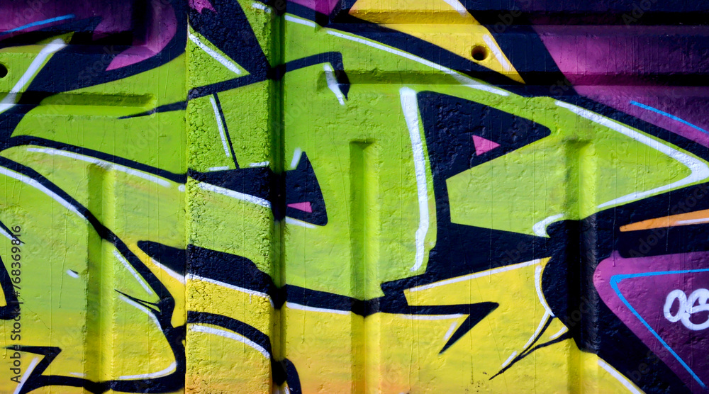 Naklejka premium Colorful background of graffiti painting artwork with bright aerosol outlines on wall. Old school street art piece made with aerosol spray paint cans. Contemporary youth culture backdrop