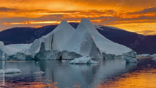 Beautiful sunset sky in Rødefjord with icebergs. Scoresbysund, Greenland. photo