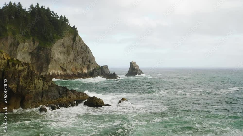 Low aerial flight towards sea in rough Pacific Ocean along Oregon Coast. Low aerial flight towards sea in rough Pacific Ocean along Oregon Coast.
