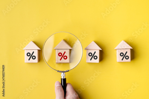 Women customer use magnifying glass finding to interest rate home is minimum, affordable alternative price, economic recession, .reduce costs, mortgage home, financial and investment concepts.