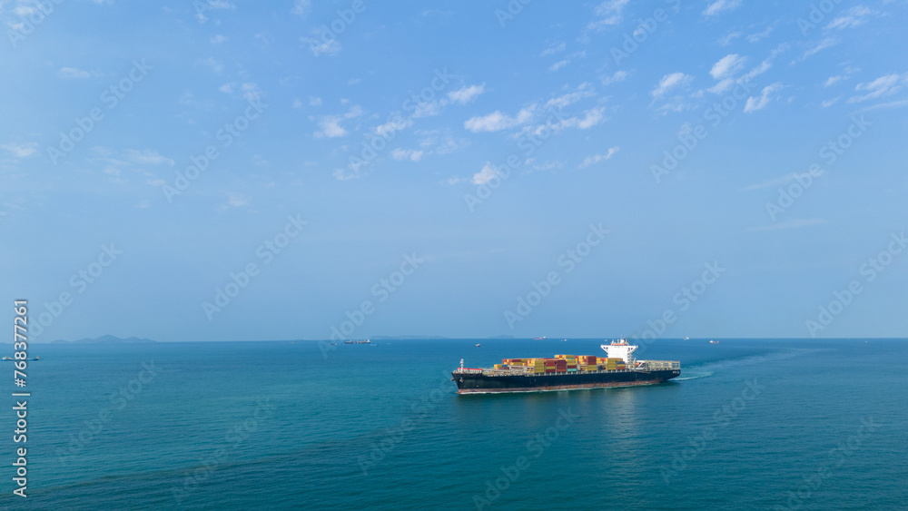 Aerial view of cargo ship with contrail in the ocean sea ship carrying container and running from container international port smart freight shipping by ship service Aerial view of cargo ship with contrail in the ocean sea ship carrying container and running from container international port smart freight shipping by ship service