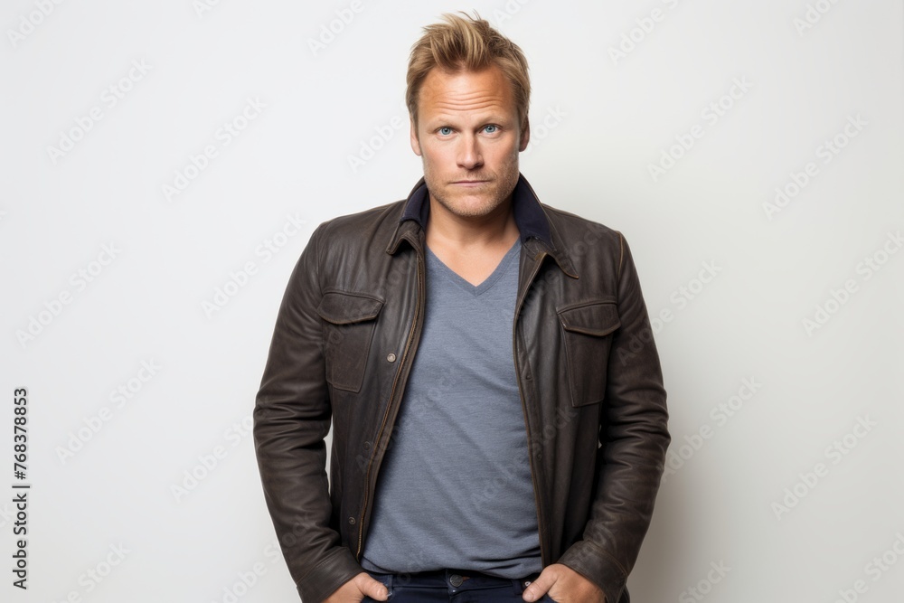 Handsome blond man in a leather jacket, looking at camera. Handsome blond man in a leather jacket, looking at camera.