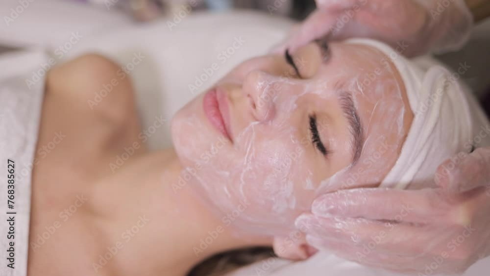 Woman receiving facial treatment, happy and relaxed at spa Woman receiving facial treatment, happy and relaxed at spa