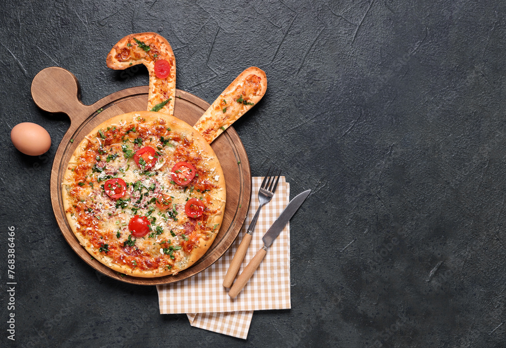 Tasty Easter pizza with bunny ears, egg and cutlery on black background - obrazy, fototapety, plakaty 