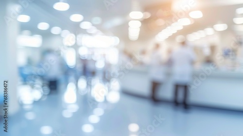 Abstract blurred image of healthcare workers moving in a busy hospital corridor for urgency and efficiency.